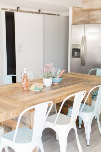 a dining room table with white chairs around it at The Shore House in Wildwood