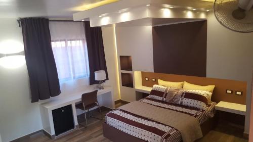 a bedroom with a large bed and a window at Hotel El Dorado in La Romana