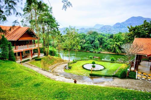 a resort with a pond in the middle of a river at Baanpufa Resort in Sai Yok