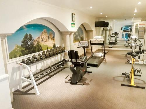 a gym with several exercise equipment in a room at Hotel PF in Mexico City