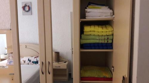 a room with a closet with towels in it at OUR ISLAND HOME 5 MINS WALK TO BEACH in Flic-en-Flac