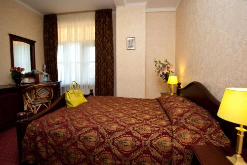 Postel nebo postele na pokoji v ubytování Boutique Hotel Monte Kristo