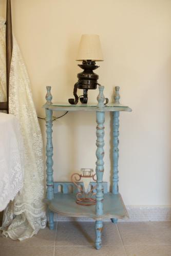 a blue end table with a lamp on it at Ancient Corinth Guest House in Kórinthos