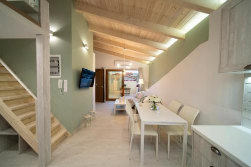 a kitchen and dining room with a white table and chairs at Feels like Home in Rethymno Town