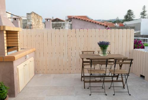 a patio with a table and chairs and a fence at Feels like Home in Rethymno Town