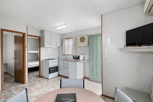 a small kitchen with a table and a room at Benalla Tourist Park in Benalla