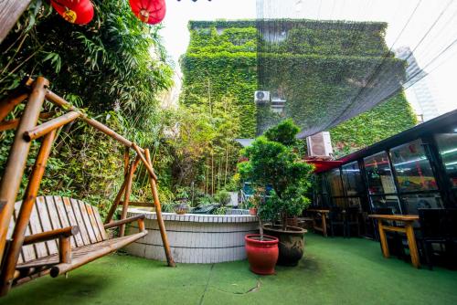 a patio with a hammock and plants in a building at MG Hotel St Michael's Cathedral, Qingdao in Qingdao