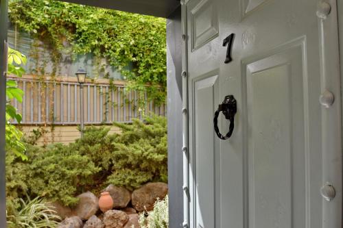 a white door with a number one on it at Out of Africa Resort in Had Nes