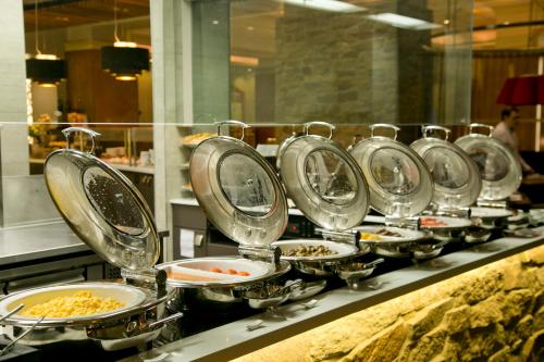 a line of plates of food on a buffet at Duxton Hotel Perth in Perth