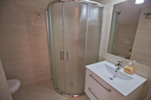 a bathroom with a shower and a sink and a toilet at Błękit Oceanu in Władysławowo