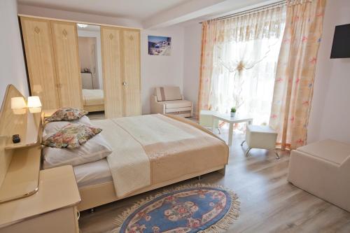 a bedroom with a large bed and a window at Błękit Oceanu in Władysławowo