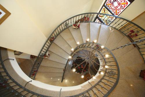 a spiral staircase with a christmas tree on it at Hotel Varosha in Lovech