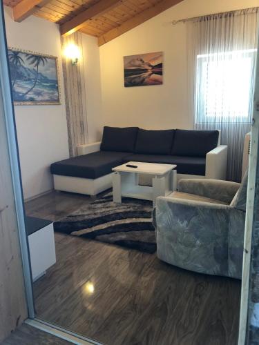 a living room with a couch and a table at Apartments Ivanković in Stari Grad