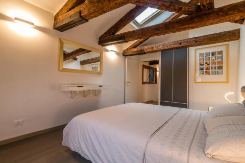 a bedroom with a white bed and wooden ceilings at SAINT MARK'S BASILICA @200 meters in Venice