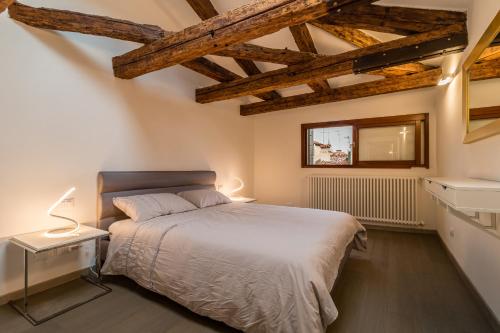 a bedroom with a bed in a room with wooden ceilings at SAINT MARK'S BASILICA @200 meters in Venice