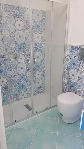 a bathroom with a toilet and a shower at Aquamarine Apartment Nel Cuore Di San Vito in San Vito lo Capo