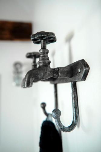 an old metal faucet hanging on a wall at Andelen Guesthouse in Ærøskøbing