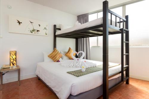 a bedroom with a bunk bed in a room at ON Hotel Phuket - SHA in Karon Beach