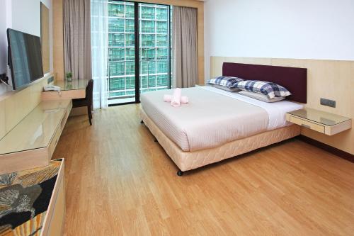 Postel nebo postele na pokoji v ubytování Bernard Holiday Home @ Imperial Suites Kuching