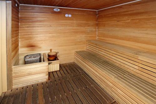 a sauna with a bench in a wooden room at Bernard Holiday Home @ Imperial Suites Kuching in Kuching