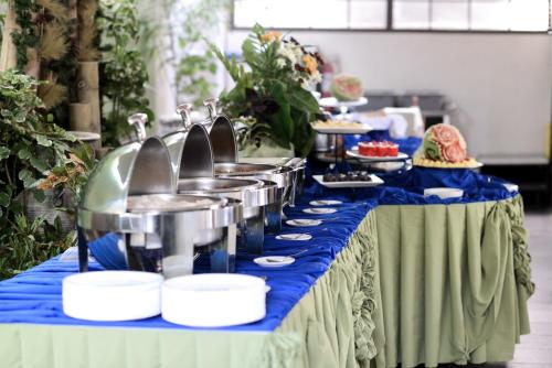 a buffet line with food on a blue table at Residencia Boracay in Boracay