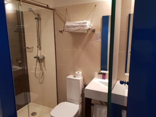 a bathroom with a shower and a toilet and a sink at El Globo in Valencia