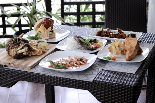 a table with four plates of food on it at Residencia Boracay in Boracay
