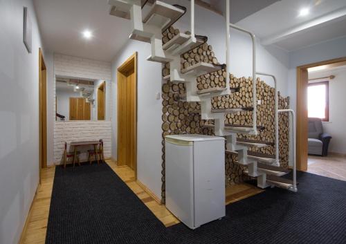 a room with a wall of fire woodalled shelves at Pensjonat Basia in Dziwnówek