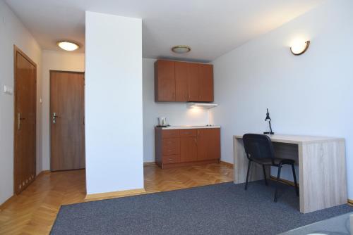 a kitchen with a desk and a chair in a room at Dobre Miejsce Dom Rekolekcyjny in Warsaw
