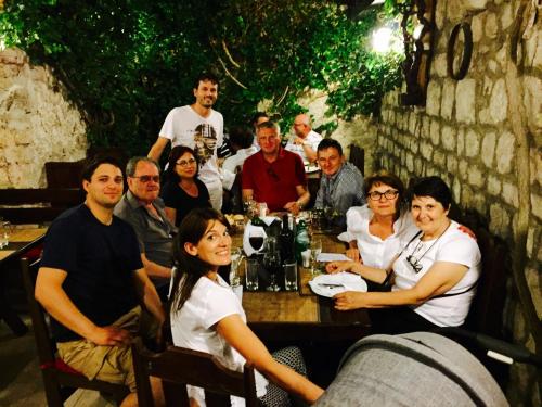 a group of people sitting around a table at Heritage Hotel Tragos in Trogir