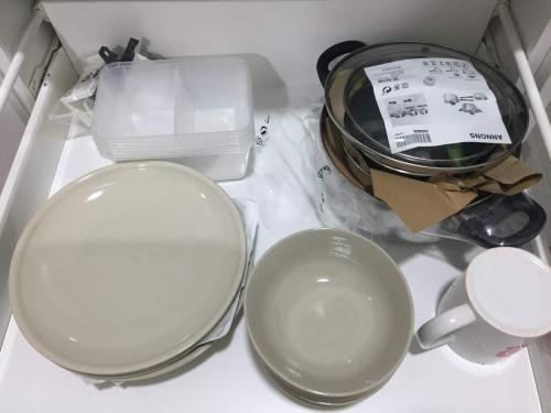 a drawer filled with dishes and a bowl and a cup at Mayzi Holiday Home @ Cyberjaya in Cyberjaya