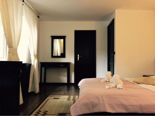 a bedroom with two beds with stuffed animals on them at Casa Codrin in Bran