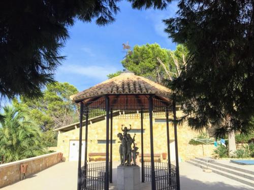 a gazebo with a statue in the middle at El Collado in Cullera