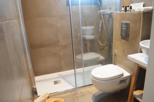 a bathroom with a shower with a toilet and a sink at Hypnos Boutique Hotel in Nicosia