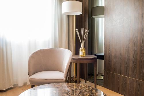 a living room with a chair and a table at Messori Suites in Florence