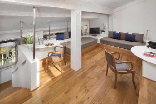 a kitchen and living room with a table and chairs at Villa Agrippina Gran Meliá – The Leading Hotels of the World in Rome