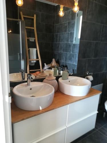 a bathroom with two sinks on a wooden counter at Villa Estée, luxury villa with private infinity pool and jacuzzi in Elounda