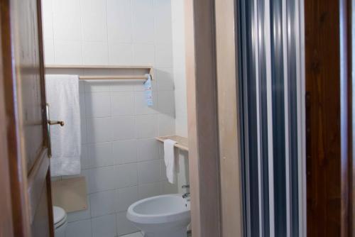 a bathroom with a white toilet and a sink at Hotel Elisabetta in Sestri Levante