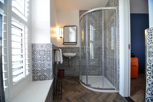 a bathroom with a shower, sink, and toilet at the Continental Boutique Residence in Galway