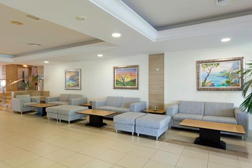 a waiting room at a hospital with couches and tables at HSM Atlantic Park in Magaluf