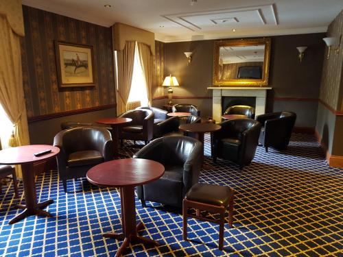 a living room filled with furniture and a table at Shap Wells Hotel in Shap