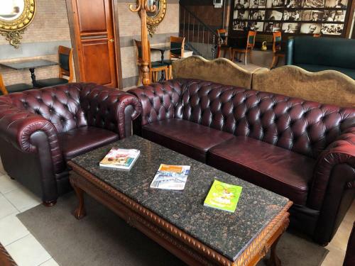 a leather couch and a table in a store at Apartment Chalet in Shakhty