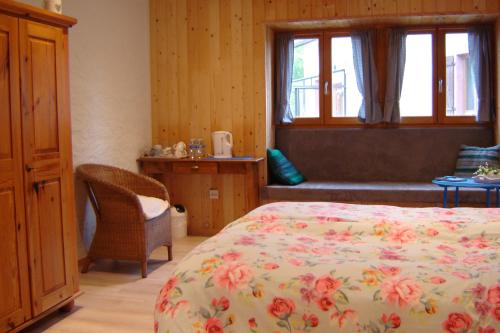 a bedroom with a bed and a window at Notre Cachette in Biffontaine