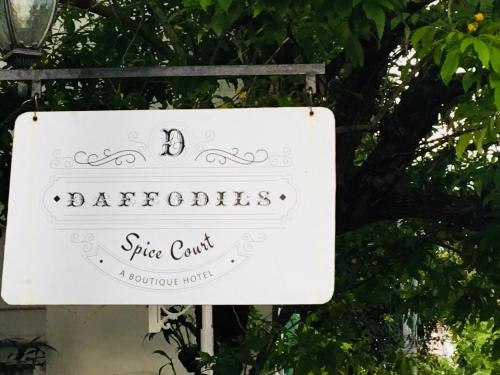 a white sign for a rite tent in front of a tree at Daffodils Spice Court in Cochin