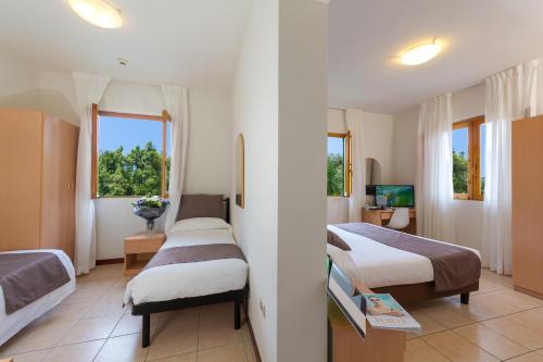 Postel nebo postele na pokoji v ubytování Hotel La Pace