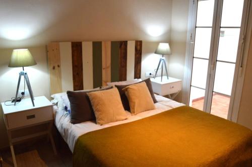 カディスにあるApartamento El Balnearioのベッドルーム1室(大型ベッド1台、ランプ2つ付)