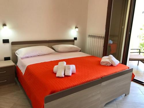 a bedroom with a bed with towels on it at Residenza Azzurra in Tropea