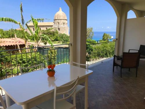 a white table and chairs on a balcony with a view at Residenza Azzurra in Tropea