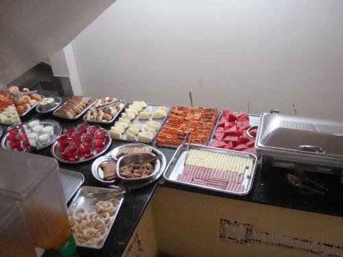 a table topped with lots of different types of food at Goias Hotel in Goiânia