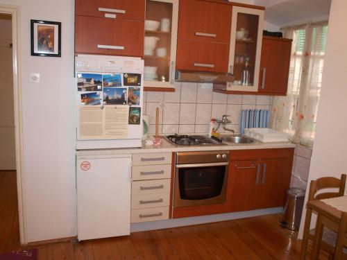 a kitchen with a white refrigerator and a microwave at Apartment 11 in Rovinj